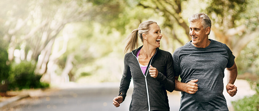 Middle Aged Couple Running Outdoors