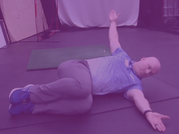Therapist Demonstrating Sidelying Trunk Exercise for Golf Perfroamnce