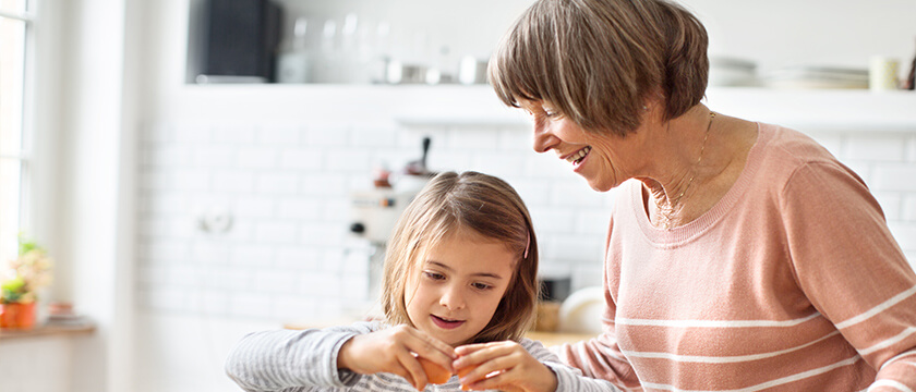 Grandmother Helping Her Grandaughter Peel an Orange