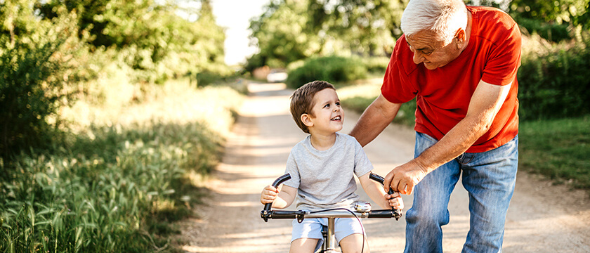 Grandfather Helping Grandson on Bike