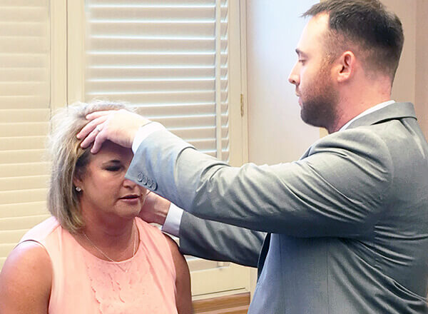 Dr. Matthew Hahn, Pain and Spine Specialist, Examining a Patient