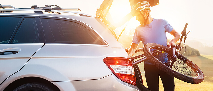 Man Unloading a Bicycle from His Car