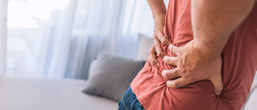Man Grasping His Lower Back
