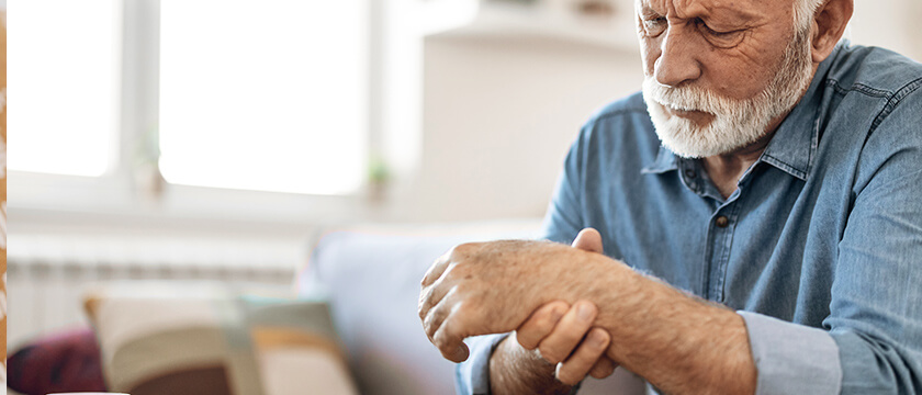 Man Grasping Wrist Arthritis
