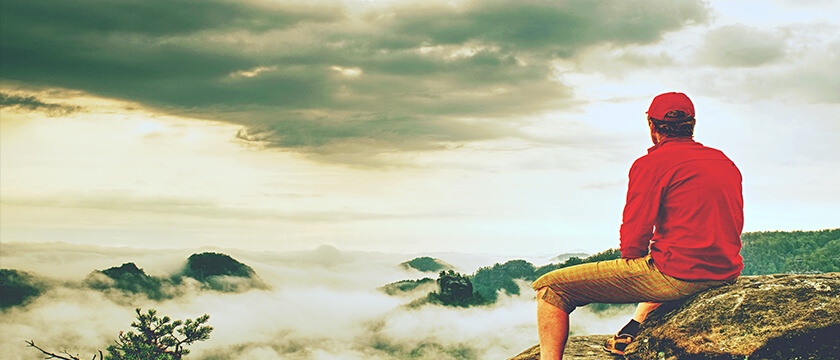 Man Resting on a Ridge for Hike