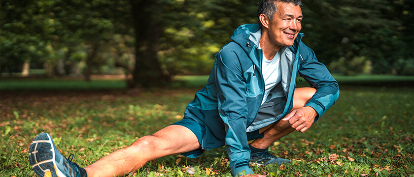 Man Stretching His Leg in The Forest