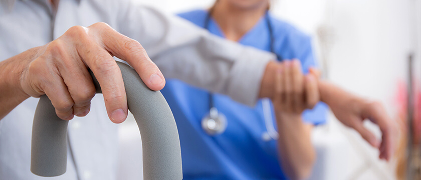Nurse Helping Patient with Cane
