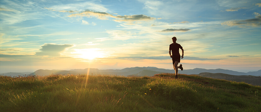 Runner on Fields at Sunset