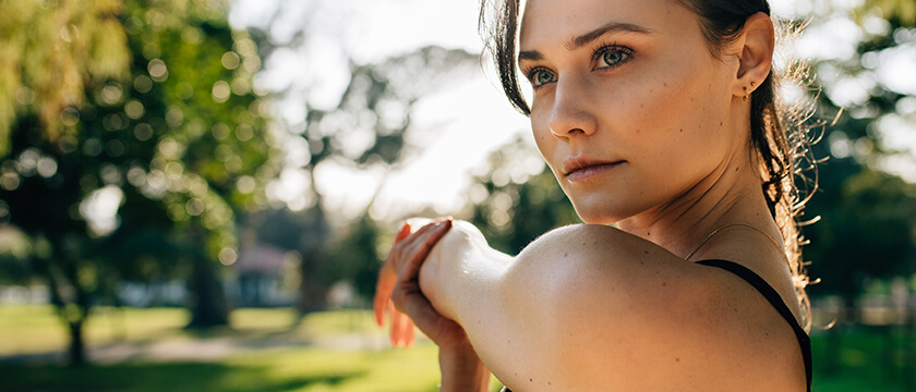 Woman Stretching Shoulder Outside