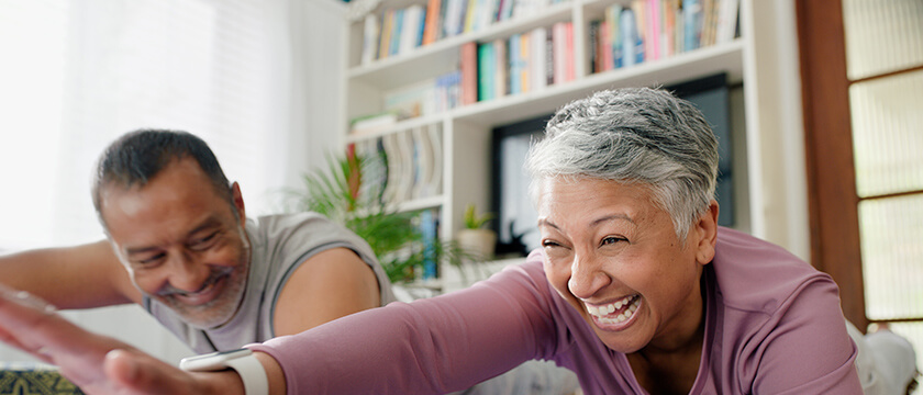 Woman Stretching Arm and Shoulder in Living Room