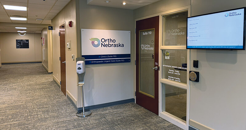 Suite 110 sign to left of door