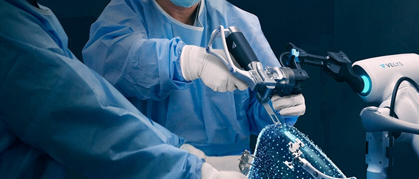 Velys Robot with Surgery Holding it and Digital Knee Imagined Concept