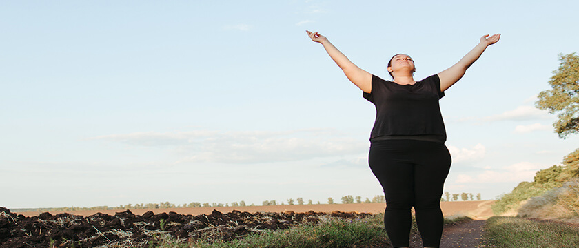 Woman Stretching Triumphantly on a Country Path