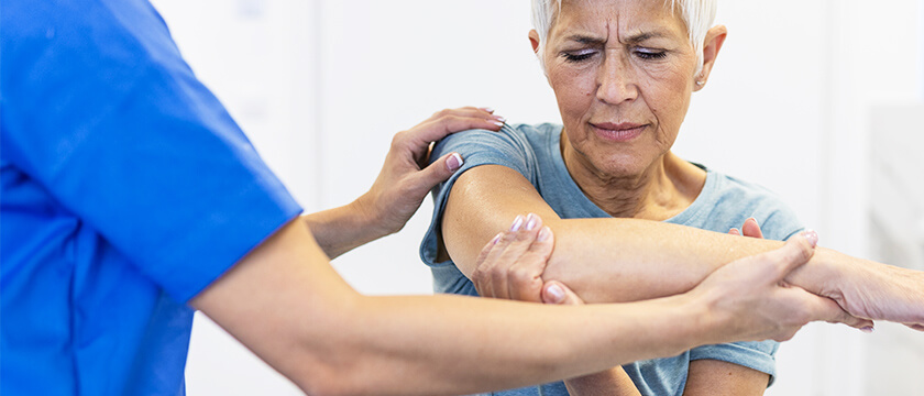 Woman Being Given an Exam for Elbow Pain