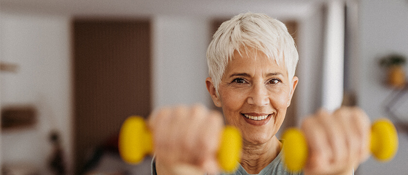 Woman Holding Up Yellow Weights