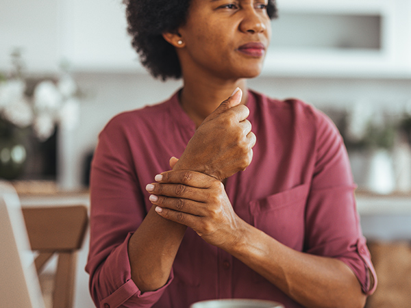Woman Working From Home Experiencing Wrist Pain