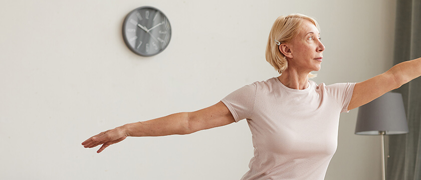 Woman Stretching Upper Body in Her Home in a Yoga Pose