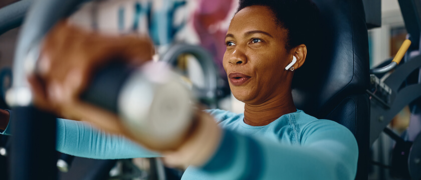 Woman Working Out By Lifting Weights Just Above Shoulder Weight