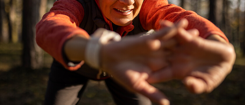 Athletic Woman Stretching Her Wrists with Fingers Interlocked