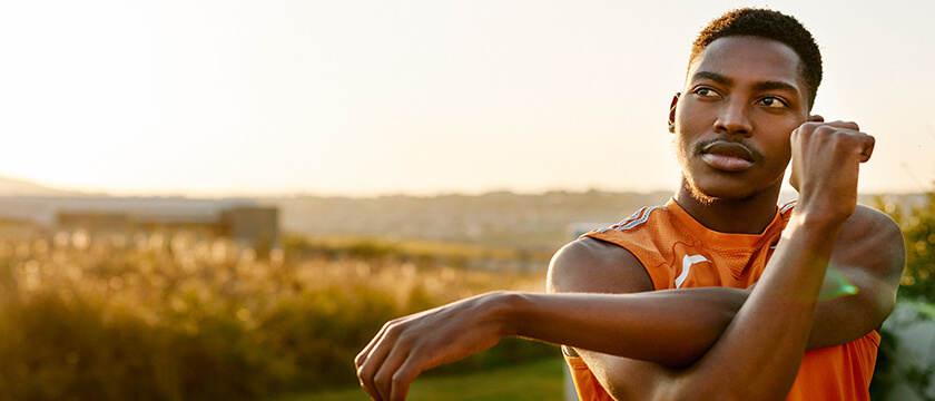 Young Black Man Stretching Shoulder Outdoors