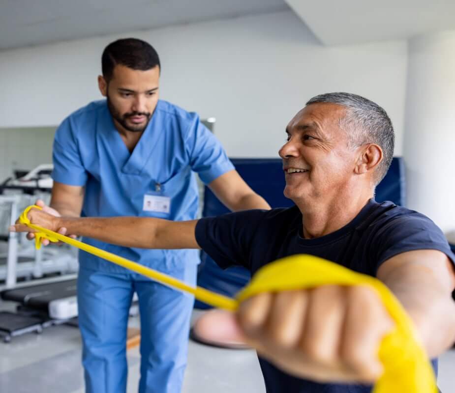Man doing resistance band exercises in physical therapy
