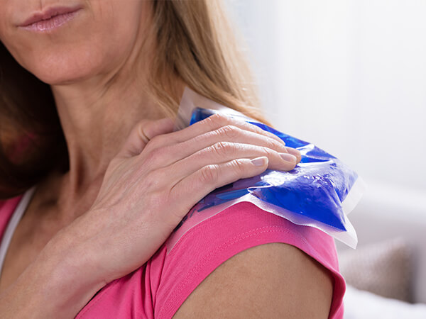 Woman Placing an Ice Pack on Her Shoulder
