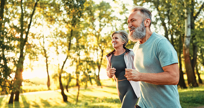 Older Couple Jogging in Park